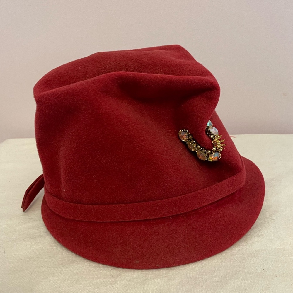 Vintage 1960s cranberry red felt hat with rhinestone attachement.